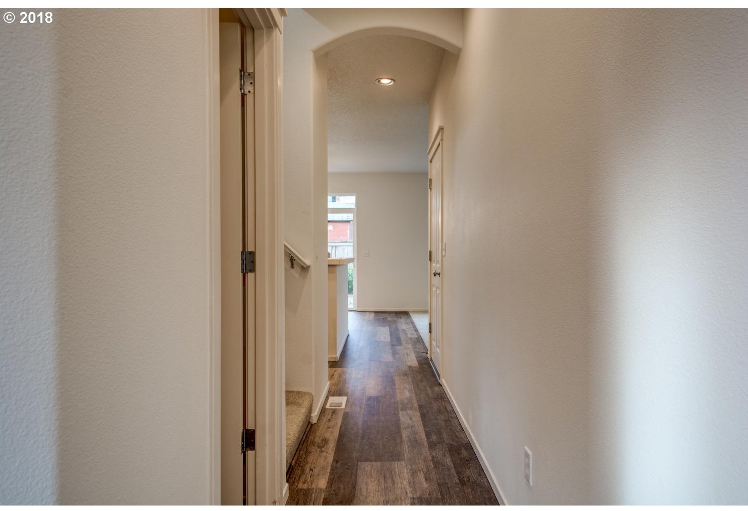 20591 Southwest Ravenswood Street Beaverton, OR 97078 - Photo 9 of 31 a view of a hallway with wooden floor and staircase