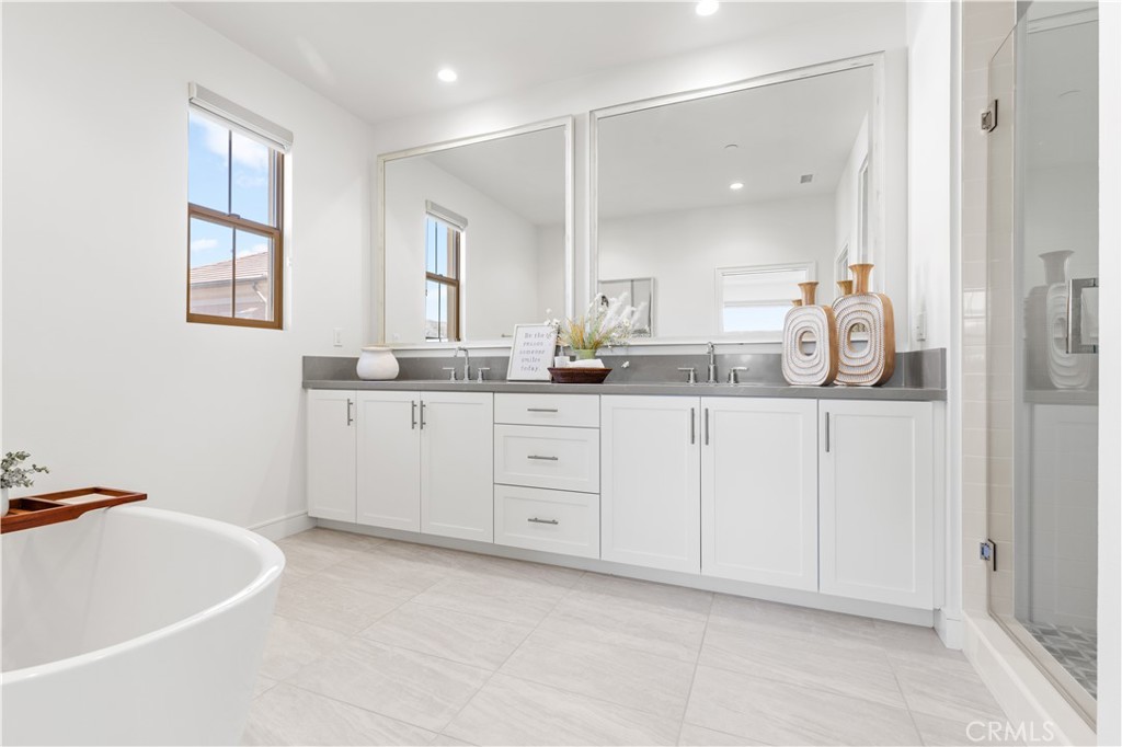 113 Halworth Irvine, CA 92618 - Photo 20 of 30 a spacious bathroom with a granite countertop sink a mirror and a