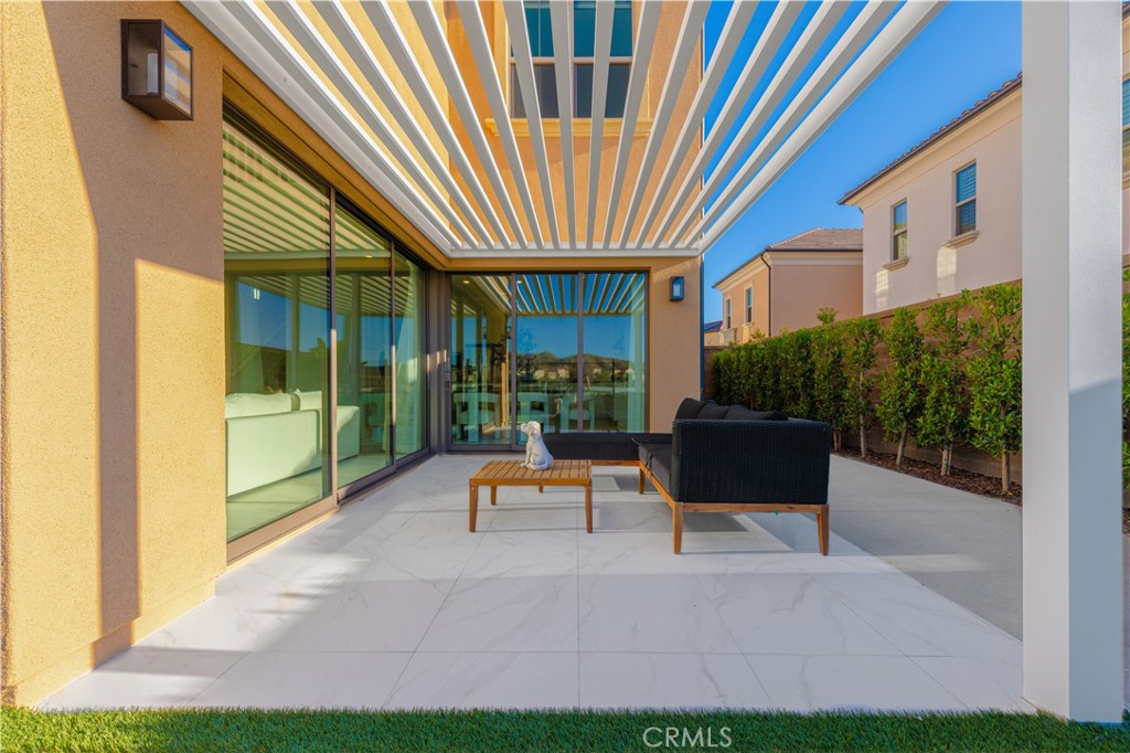 113 Halworth Irvine, CA 92618 - Photo 4 of 30 a view of patio with a table and chairs under an umbrella