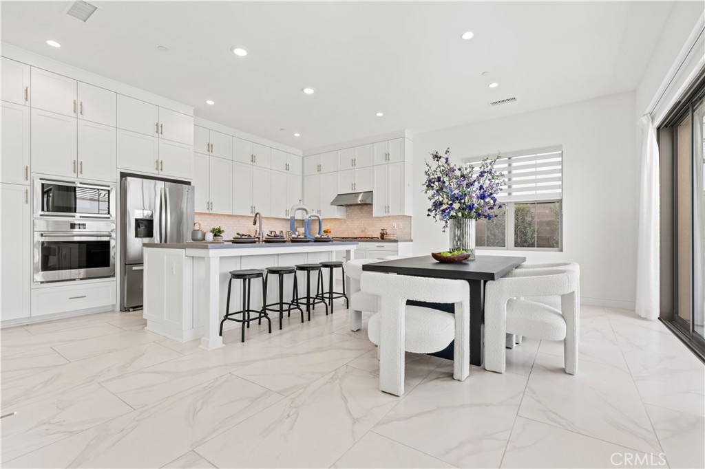 113 Halworth Irvine, CA 92618 - Photo 8 of 30 a kitchen with stainless steel appliances kitchen island granite countertop a sink and a refrigerator