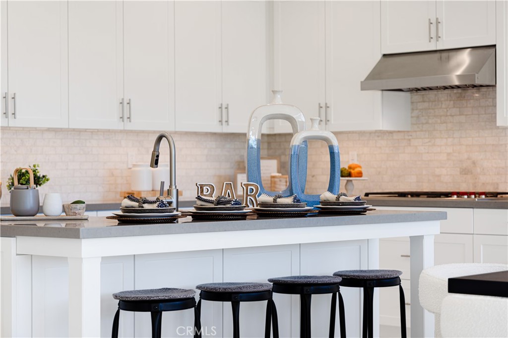 113 Halworth Irvine, CA 92618 - Photo 10 of 30 a kitchen with a sink a stove and white cabinets