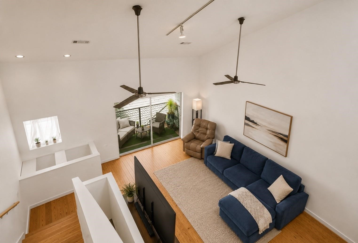 708 Ruthven Street Houston, TX 77019 - Photo 5 of 17 Virtually staged living room showcasing the skylight and natural light flooding in.