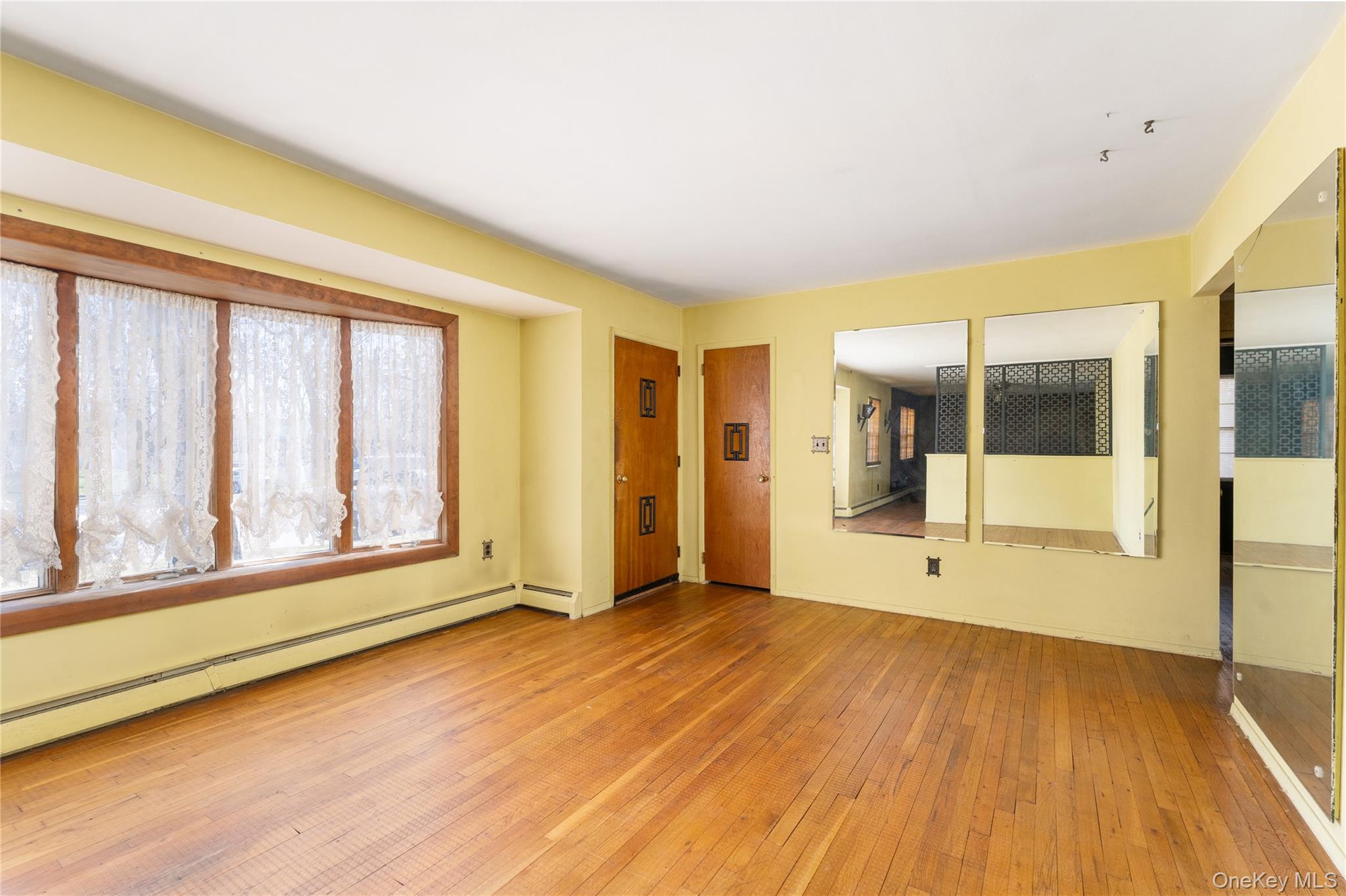 52 Woodbury Road Farmingville, NY 11738 - Photo 2 of 25 Wood floors, picture window open to Dining Room and Den