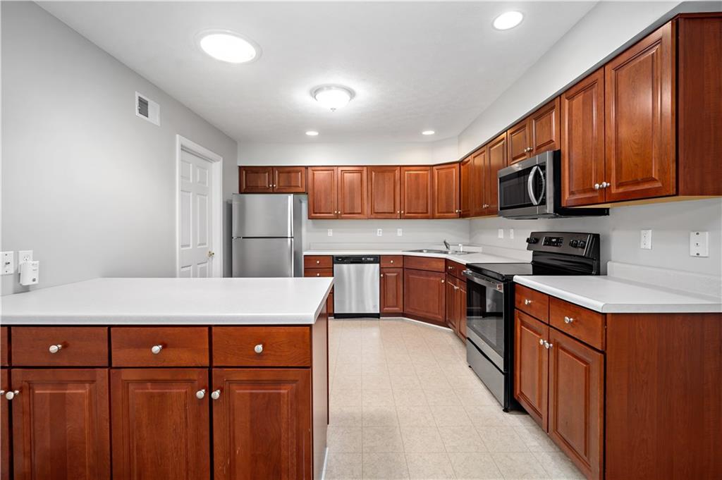 179 Rana Lane Gibsonia, PA 15044 - Photo 11 of 25 a kitchen with stainless steel appliances granite countertop wooden cabinets a stove top oven a sink and dishwasher