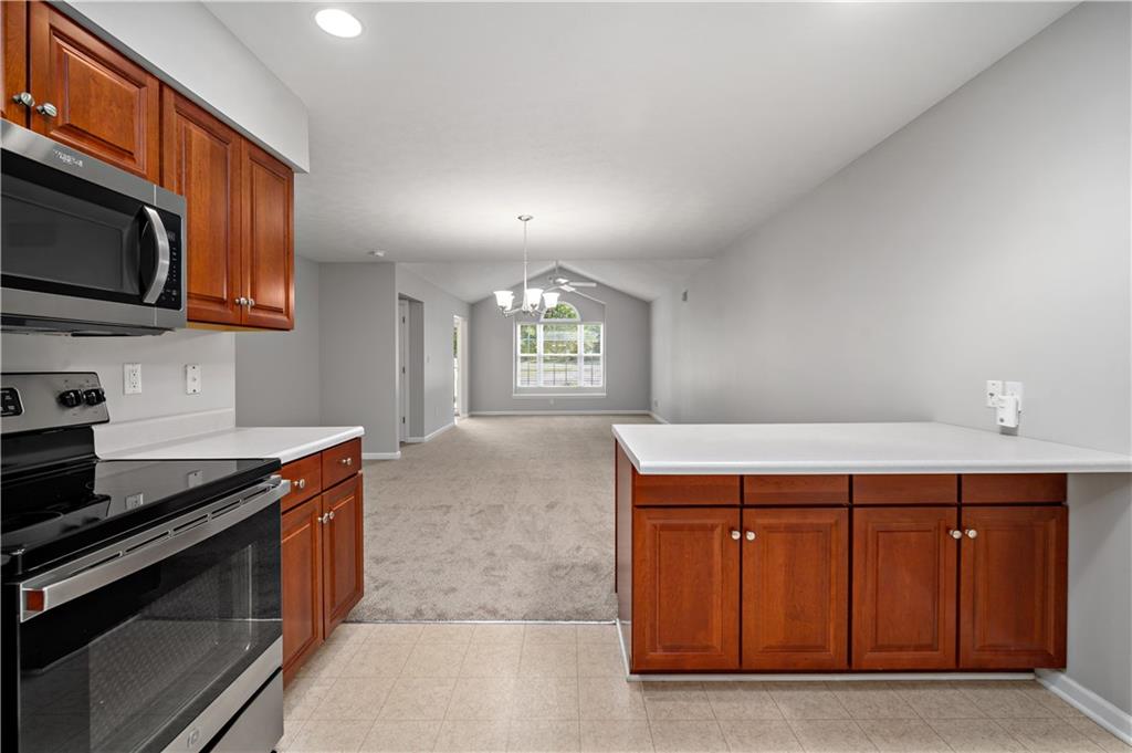179 Rana Lane Gibsonia, PA 15044 - Photo 12 of 25 a kitchen with stainless steel appliances granite countertop a stove a sink and a microwave