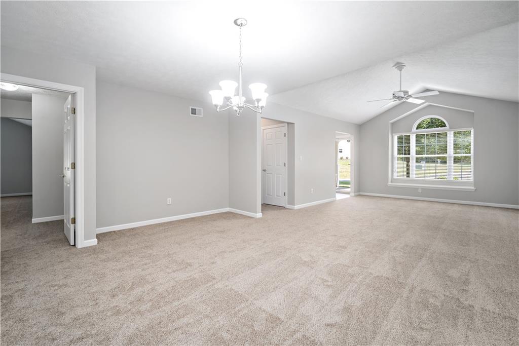 179 Rana Lane Gibsonia, PA 15044 - Photo 8 of 25 an empty room with chandelier and windows