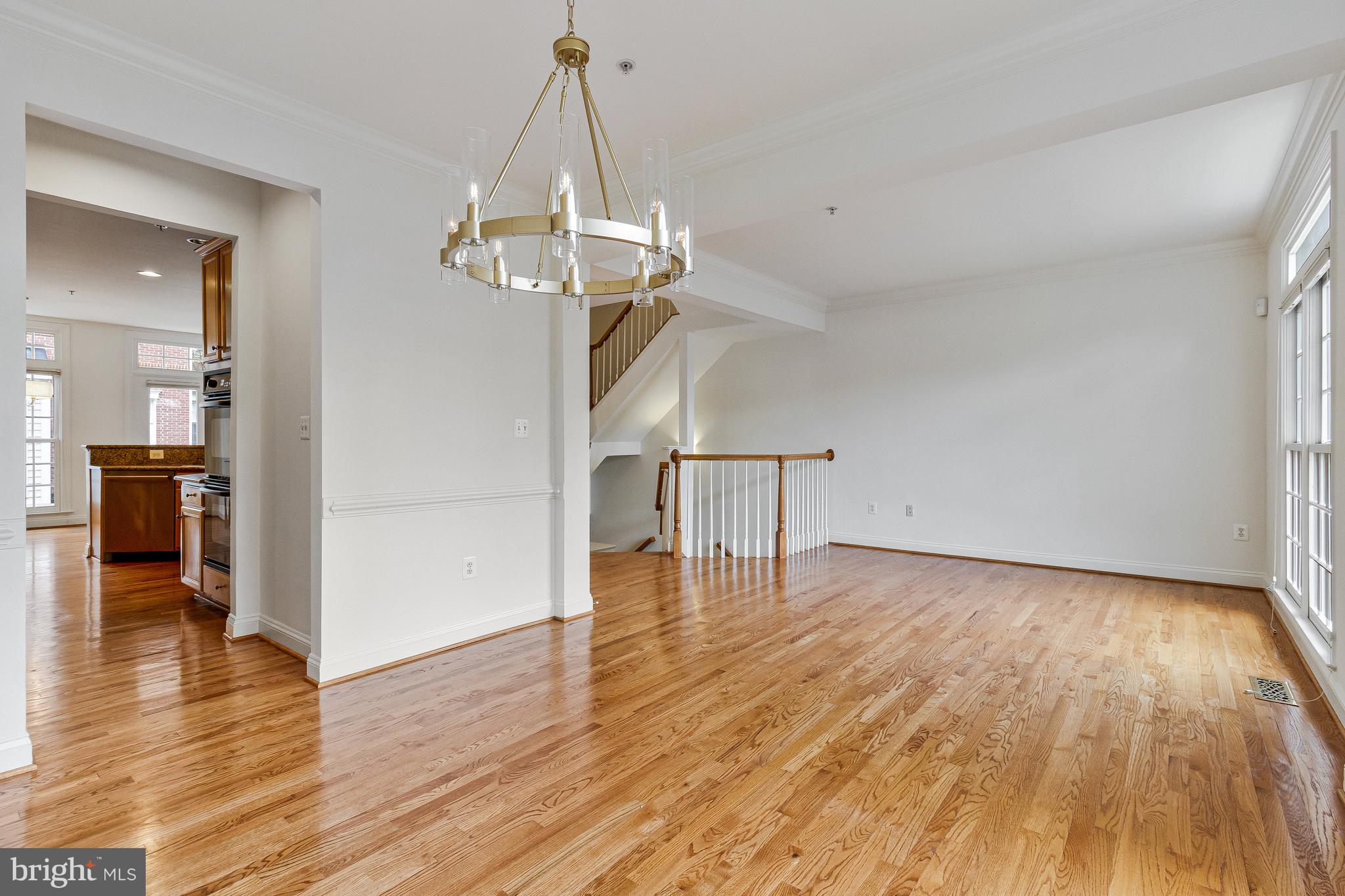 1646 Colonial Hills Drive McLean, VA 22102 - Photo 12 of 39 a view of a livingroom with wooden floor a ceiling fan and kitchen space