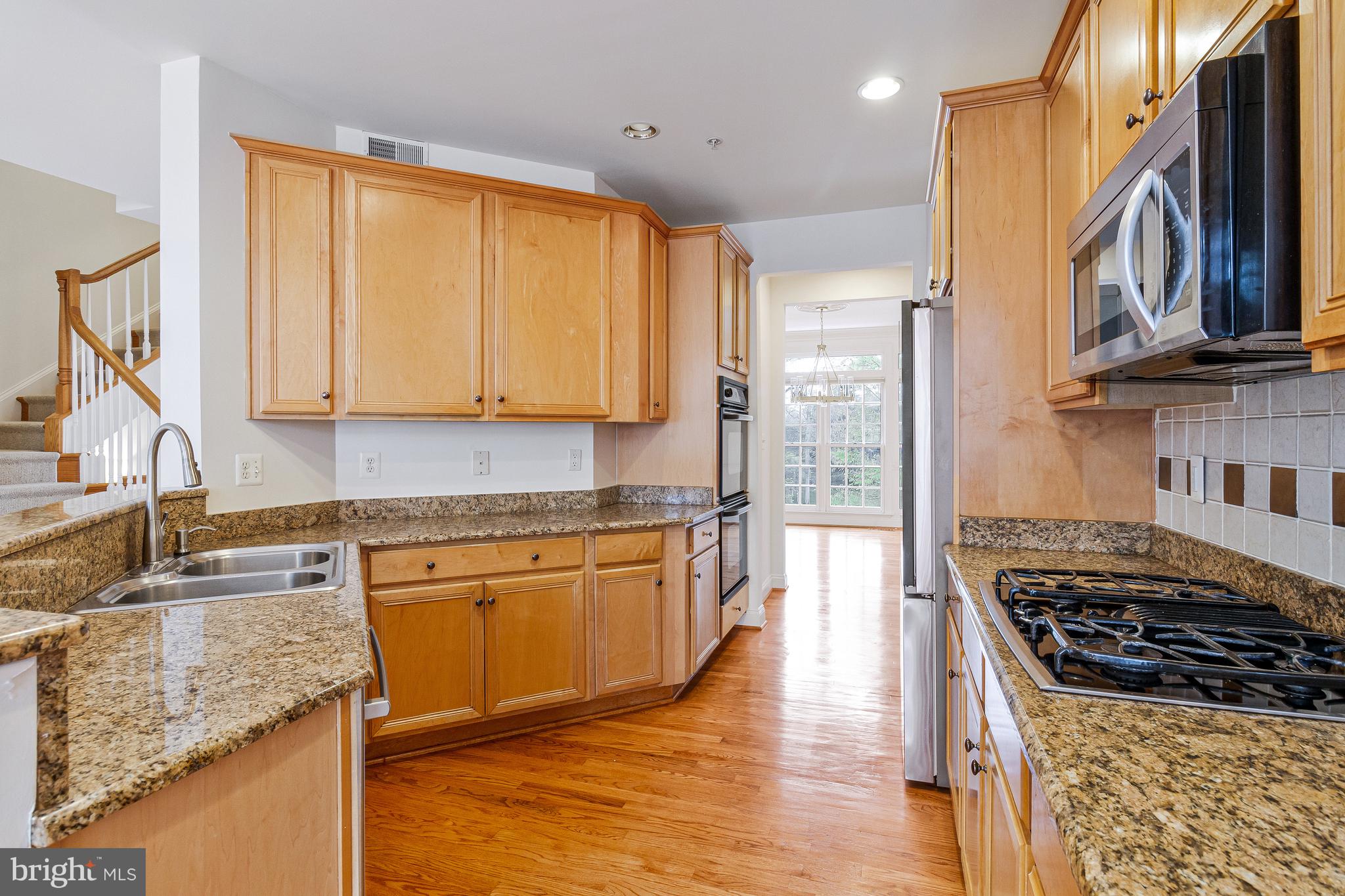 1646 Colonial Hills Drive McLean, VA 22102 - Photo 14 of 39 a kitchen with stainless steel appliances granite countertop a stove a sink and a microwave