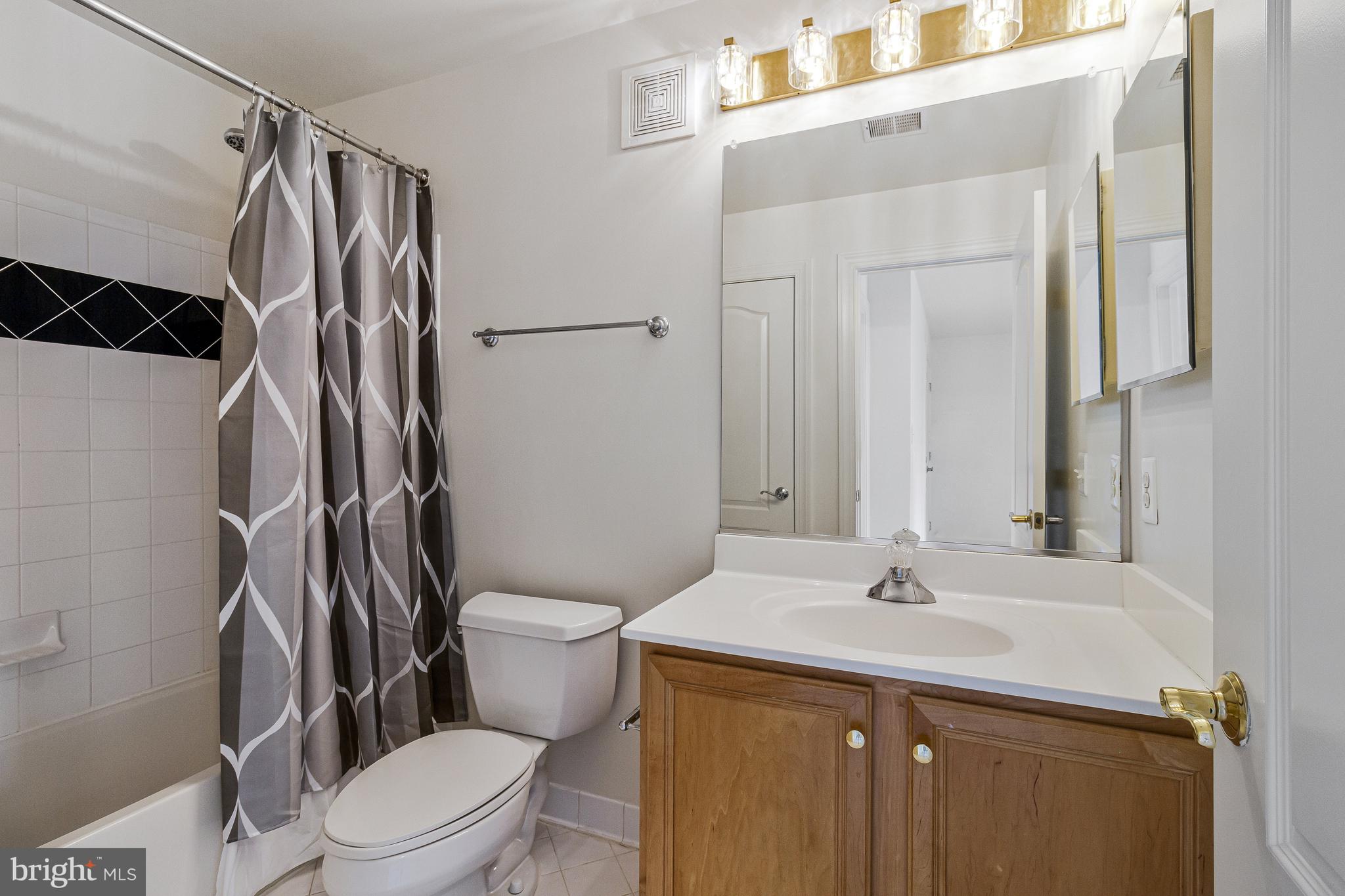 1646 Colonial Hills Drive McLean, VA 22102 - Photo 29 of 39 a bathroom with a sink a toilet and shower