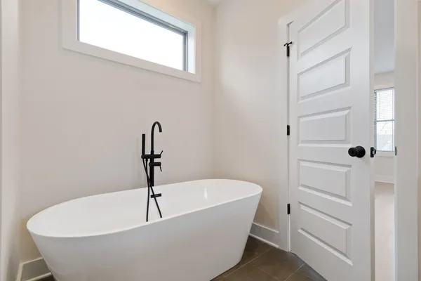 a white bath tub sitting in a bathroom
