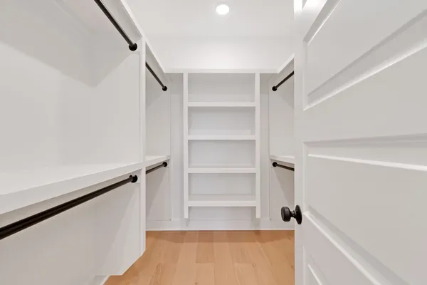 a view of walk in closet with empty racks