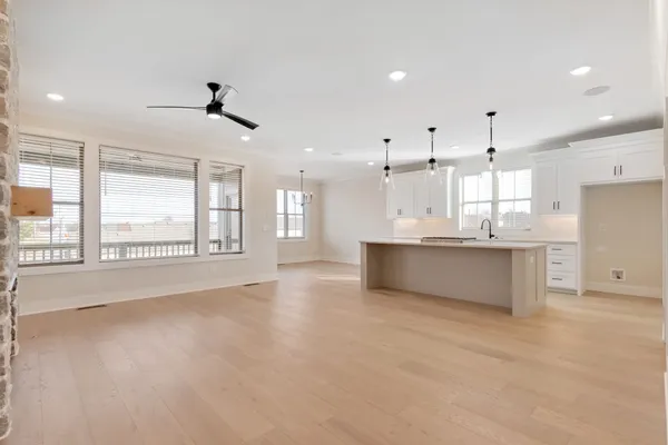 a large kitchen with stainless steel appliances kitchen island a large counter top and a fireplace