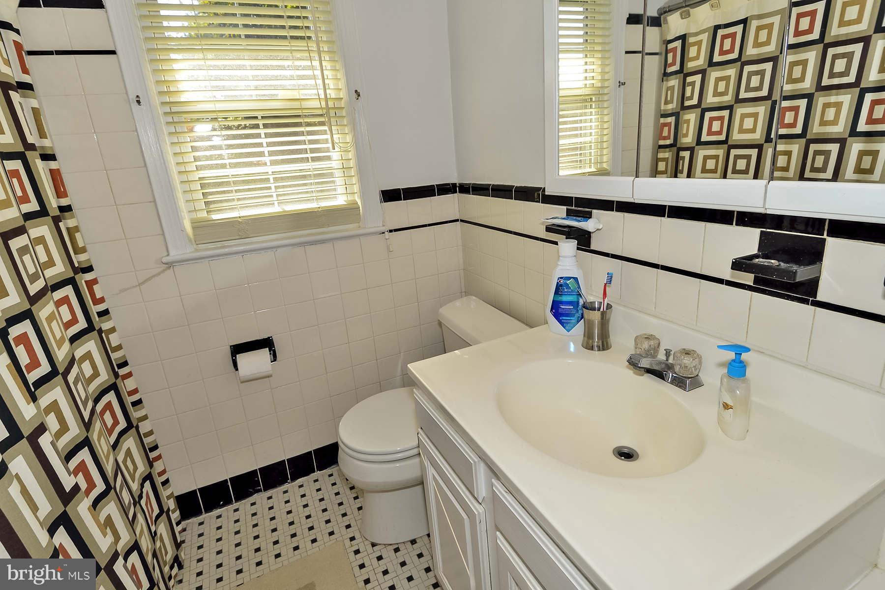 110 Normandy Drive Silver Spring, MD 20901 - Photo 11 of 20 a bathroom with a sink and a toilet