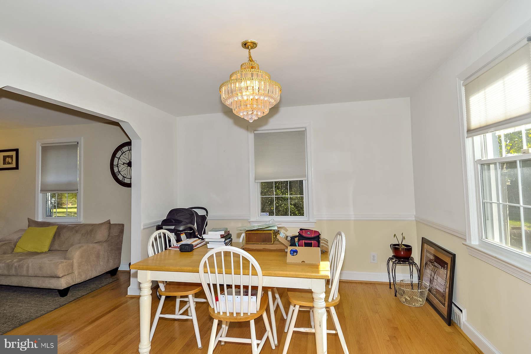 110 Normandy Drive Silver Spring, MD 20901 - Photo 4 of 20 a view of a dining room with furniture a chandelier and wooden floor
