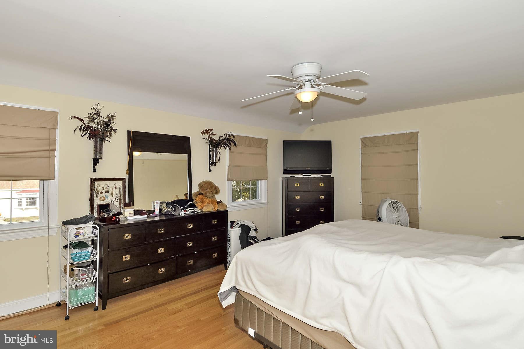 110 Normandy Drive Silver Spring, MD 20901 - Photo 10 of 20 a bedroom with a bed and a chandelier