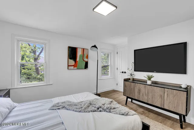 a bedroom with a bed and a flat screen tv