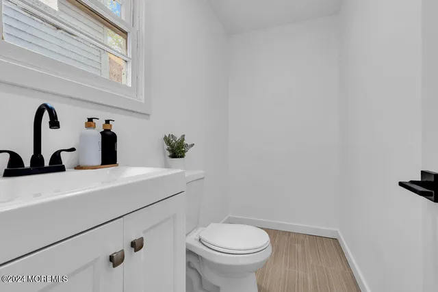 a bathroom with a sink a toilet and mirror