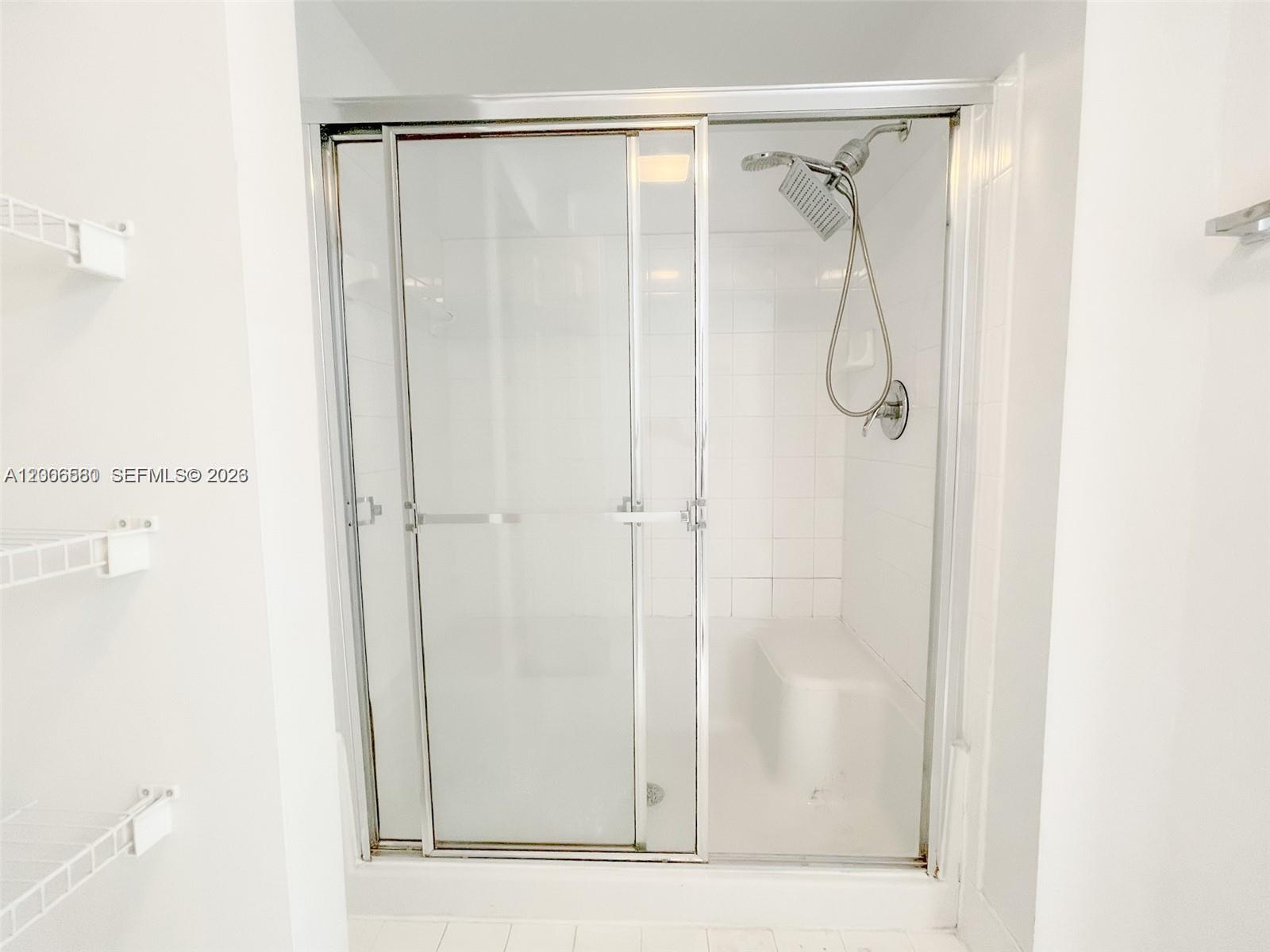 17150 North Bay Road, Unit 2602 Sunny Isles Beach, FL 33160 - Photo 26 of 27 a bathroom with a glass shower door