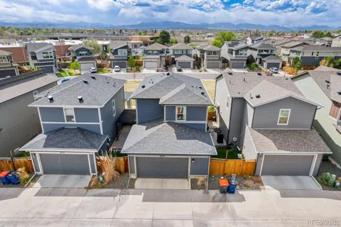 an aerial view of a house with a swimming pool and outdoor seating