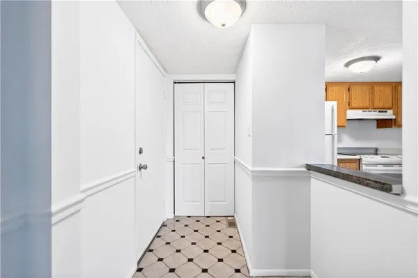 a bathroom with a sink a light fixture and a shower