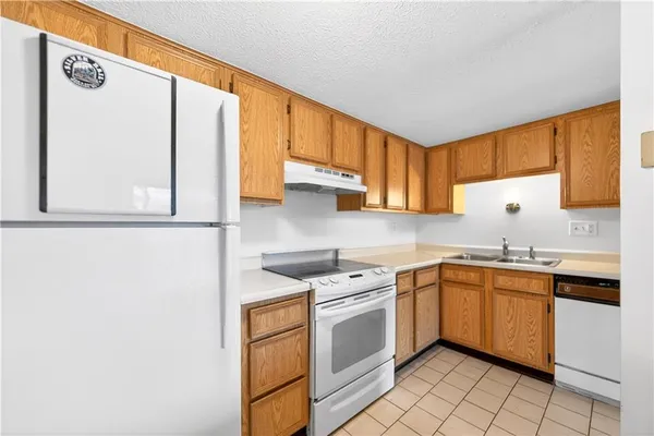 a kitchen with a sink cabinets and window