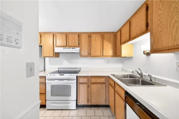 a kitchen with a sink cabinets and a window