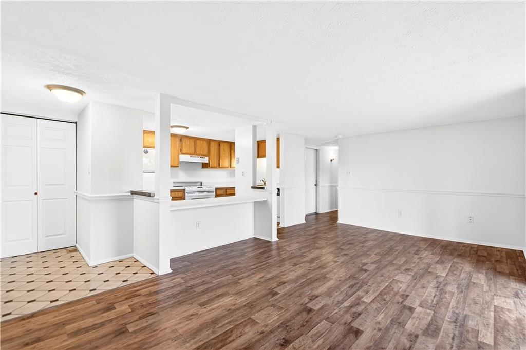 231 Coxcomb Hill Road, Unit 4 New Kensington, PA 15068 - Photo 9 of 23 a kitchen with granite countertop a stove and white cabinets