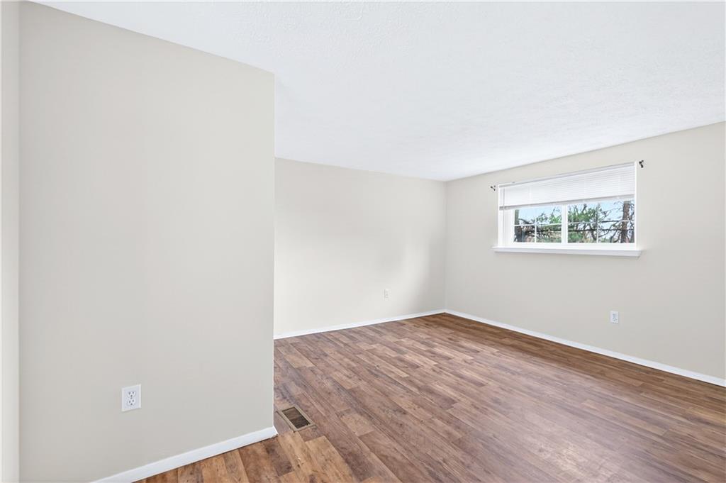 231 Coxcomb Hill Road, Unit 4 New Kensington, PA 15068 - Photo 10 of 23 an empty room with wooden floor and window