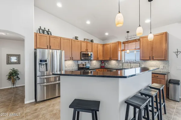 a kitchen with stainless steel appliances granite countertop a sink a stove and a microwave