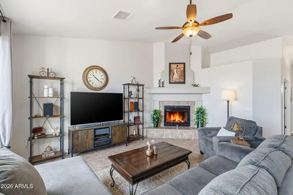 a living room with furniture a fireplace and a flat screen tv