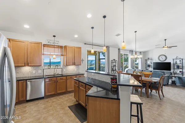 a kitchen with stainless steel appliances granite countertop a sink and stove
