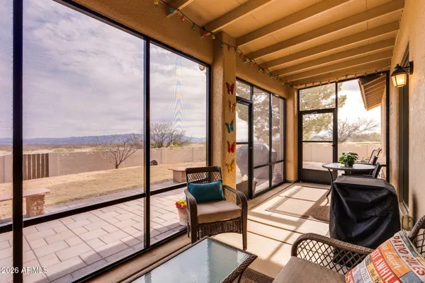 a bedroom with furniture and large windows