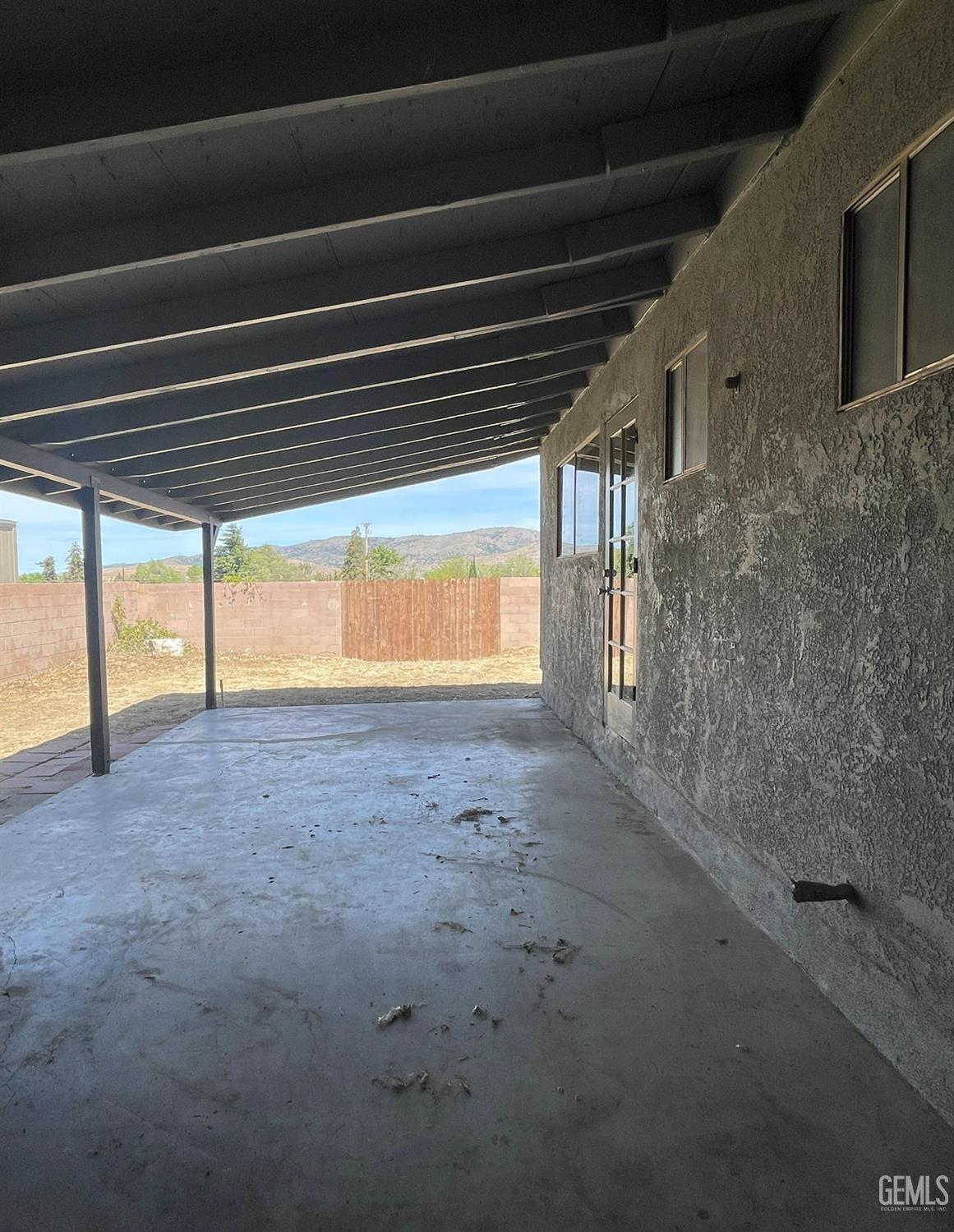 Undisclosed Address Tehachapi, CA 93561 - Photo 13 of 18 a view of empty room with wooden floor and fan