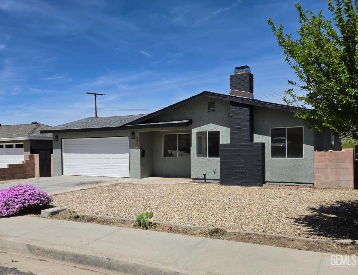 Undisclosed Address Tehachapi, CA 93561 - Photo 18 of 18 a front view of a house with a garage