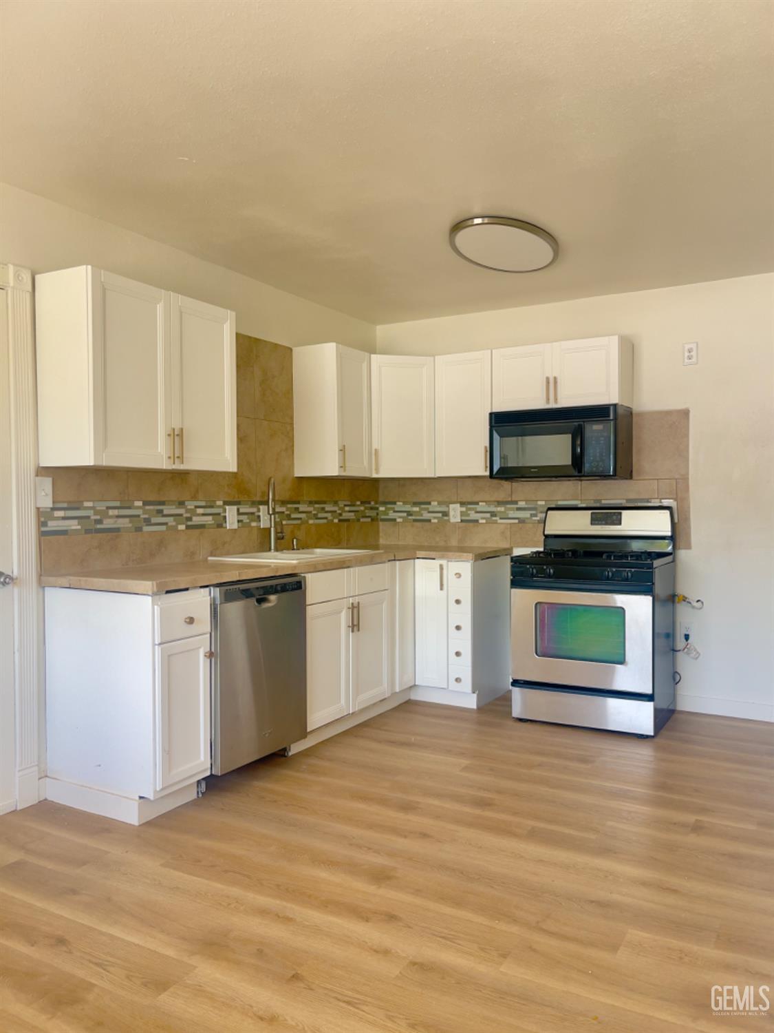 Undisclosed Address Tehachapi, CA 93561 - Photo 4 of 18 a kitchen with stainless steel appliances granite countertop a stove a sink and a microwave