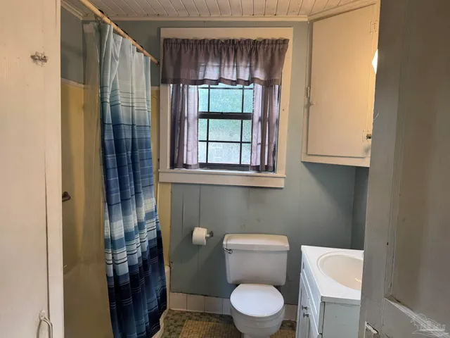 a white toilet sitting next to a bathroom sink