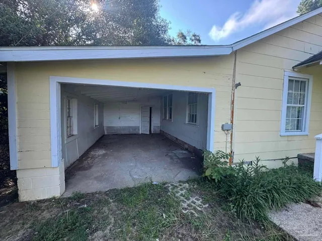 a view of a house with a yard and sitting area