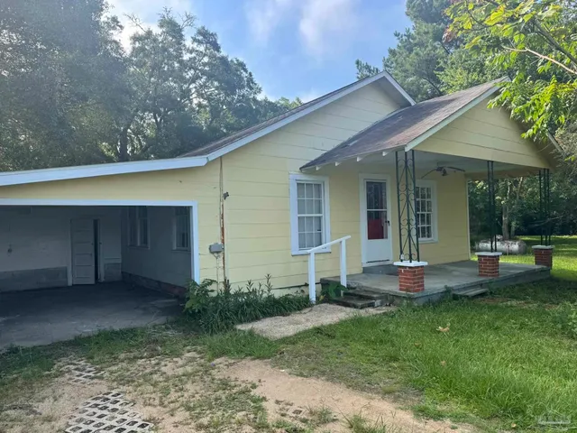 an aerial view of residential house with outdoor space and seating