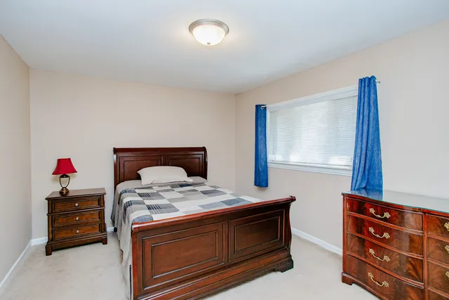 a bed room with a bed and a dresser