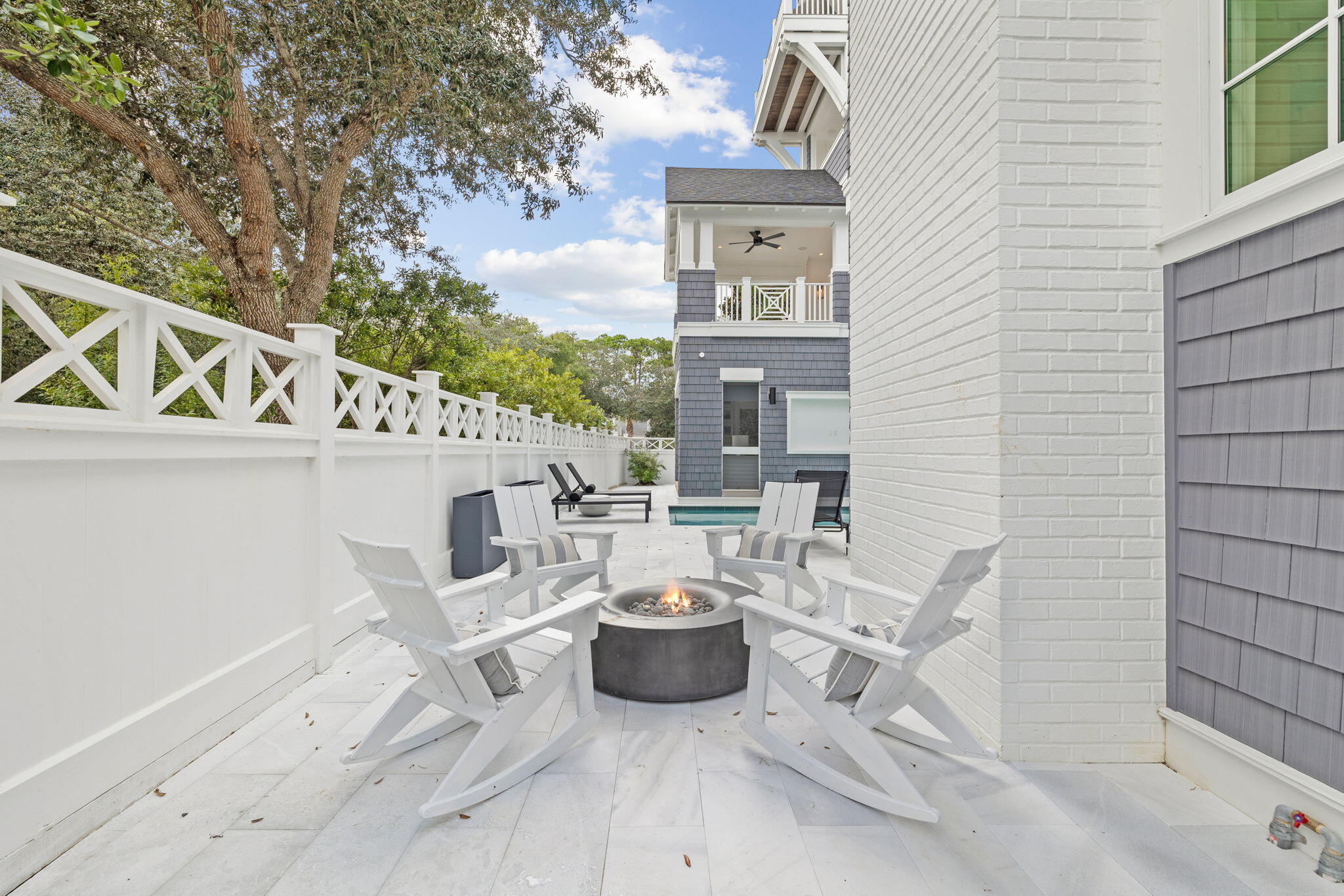 17 North Watch Tower Lane Watersound, FL 32461 - Photo 53 of 195 a view of a patio with table and chairs potted plants with wooden floor and fence