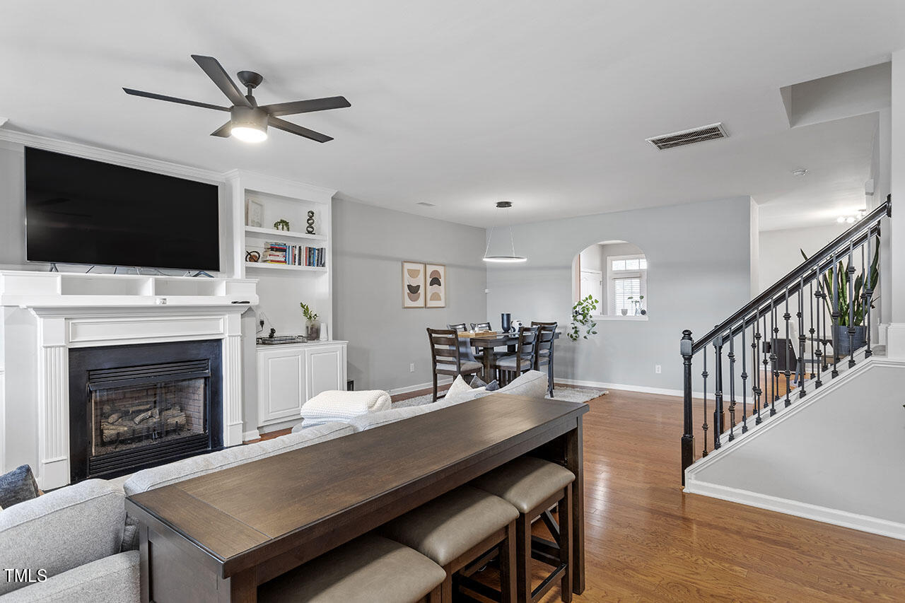 1329 Still Monument Way Raleigh, NC 27603 - Photo 10 of 42 a living room with furniture a fireplace and a flat screen tv