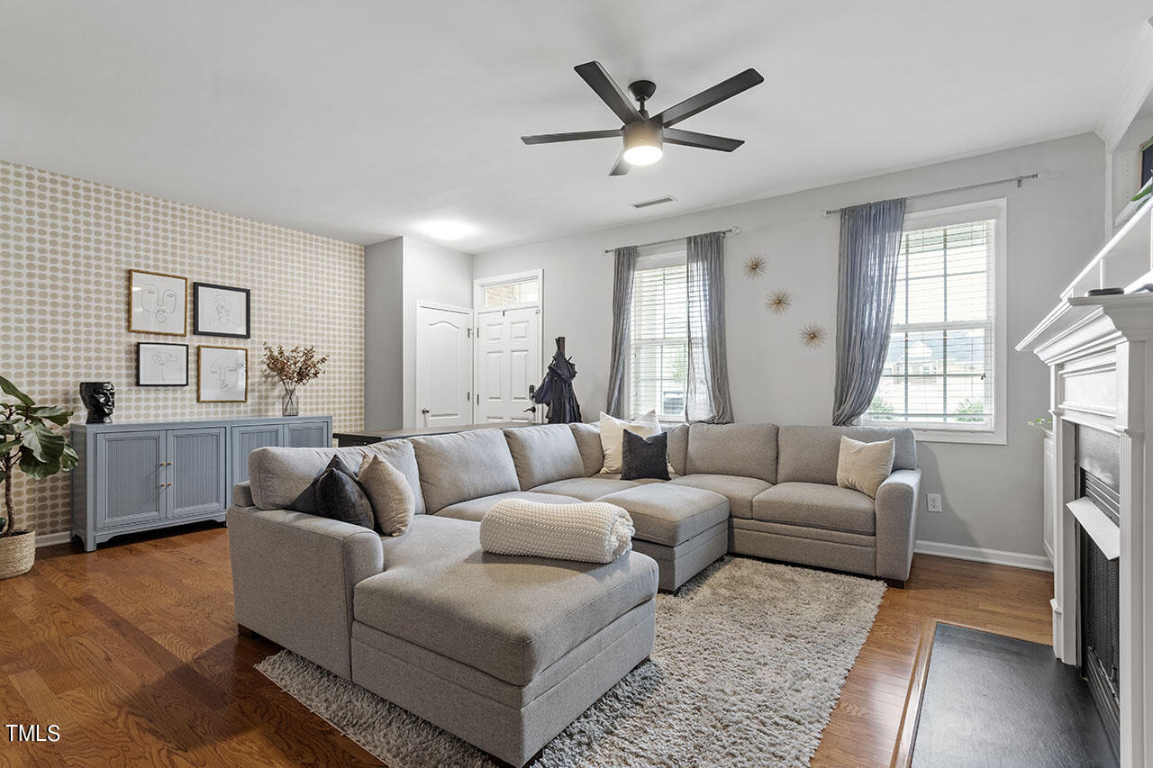 1329 Still Monument Way Raleigh, NC 27603 - Photo 13 of 42 a living room with furniture a fireplace and a window