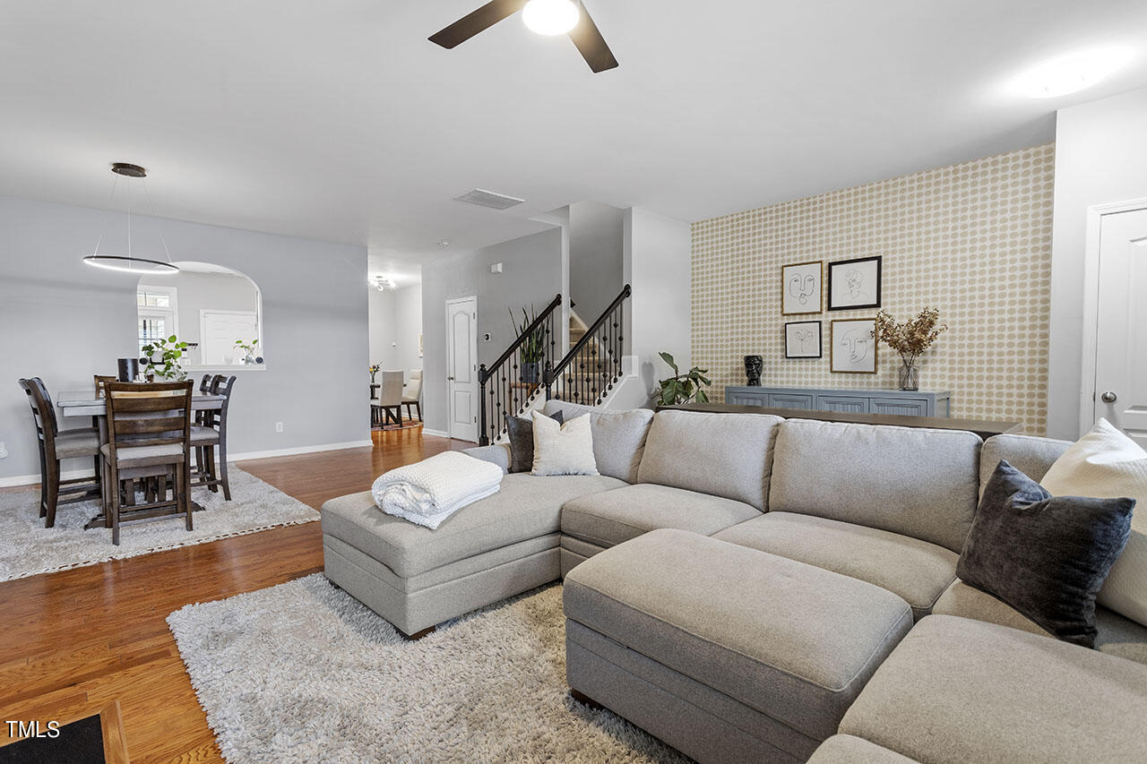 1329 Still Monument Way Raleigh, NC 27603 - Photo 14 of 42 a living room with furniture and wooden floor