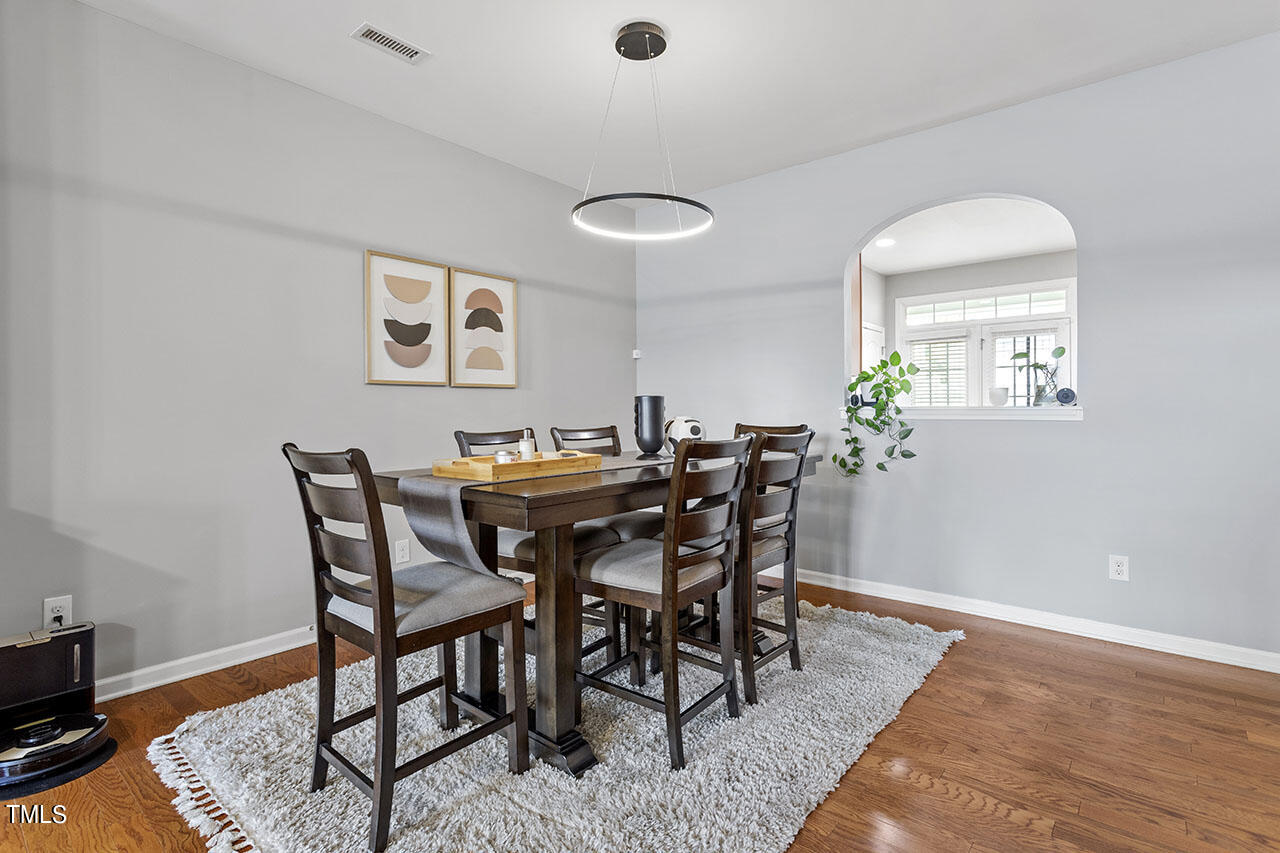 1329 Still Monument Way Raleigh, NC 27603 - Photo 15 of 42 a view of a dining room with furniture and wooden floor