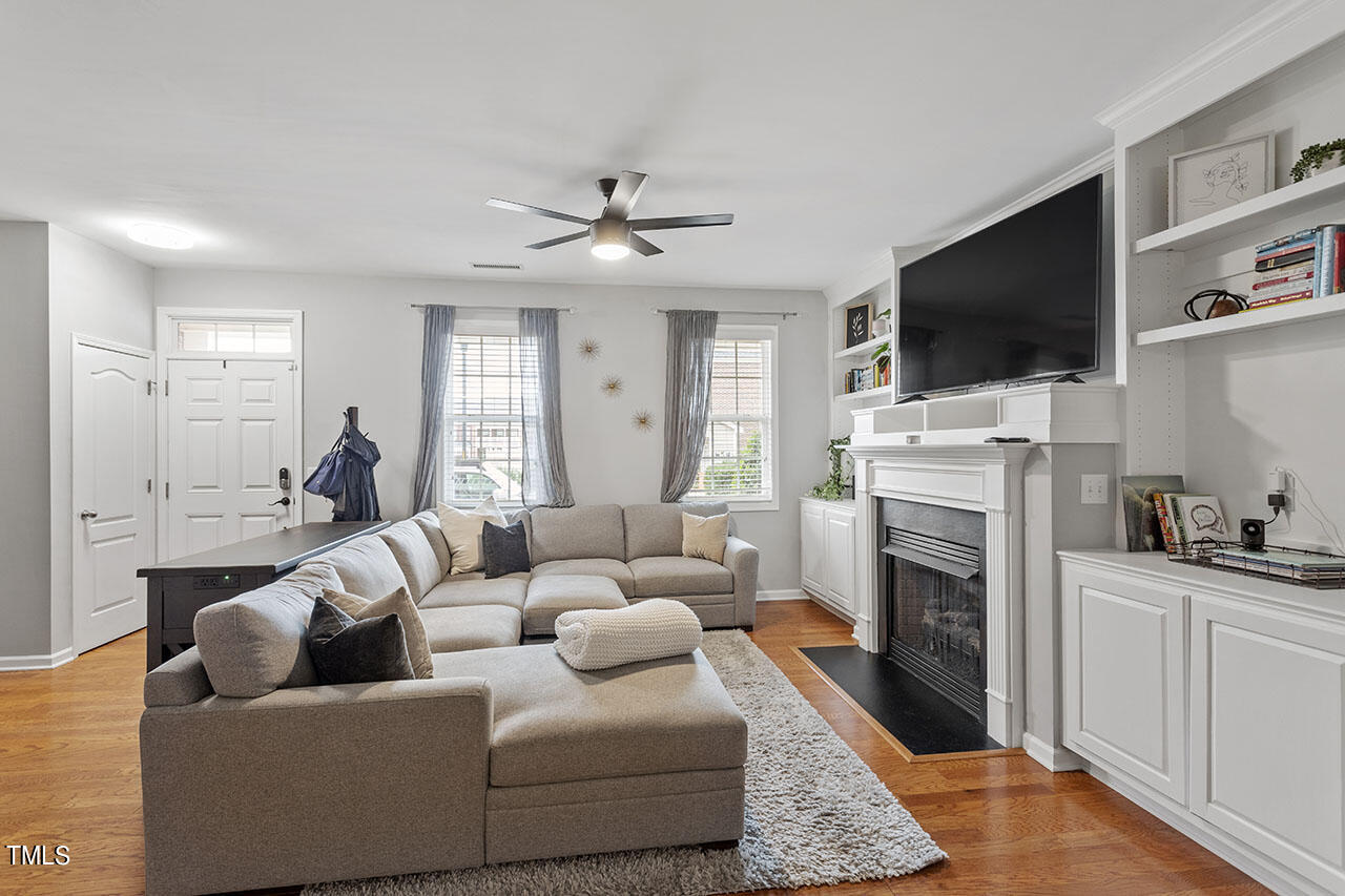 1329 Still Monument Way Raleigh, NC 27603 - Photo 2 of 42 a living room with furniture a flat screen tv and a fireplace