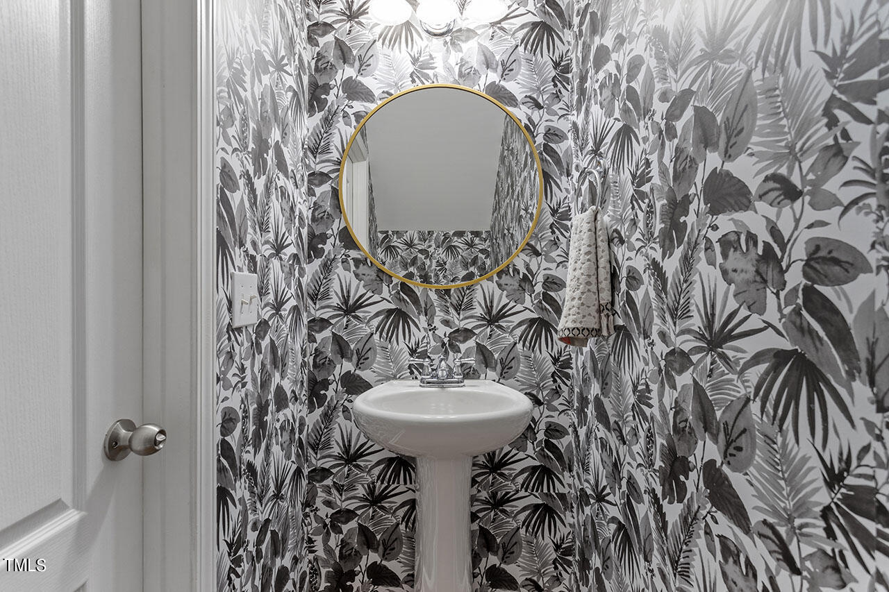 1329 Still Monument Way Raleigh, NC 27603 - Photo 20 of 42 a bathroom with a sink and mirror