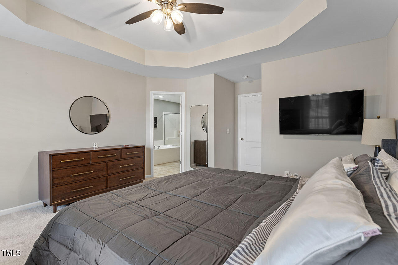 1329 Still Monument Way Raleigh, NC 27603 - Photo 22 of 42 a bedroom with a bed and a flat screen tv