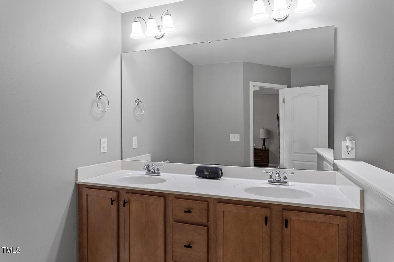1329 Still Monument Way Raleigh, NC 27603 - Photo 25 of 42 a bathroom with double sink and a mirror