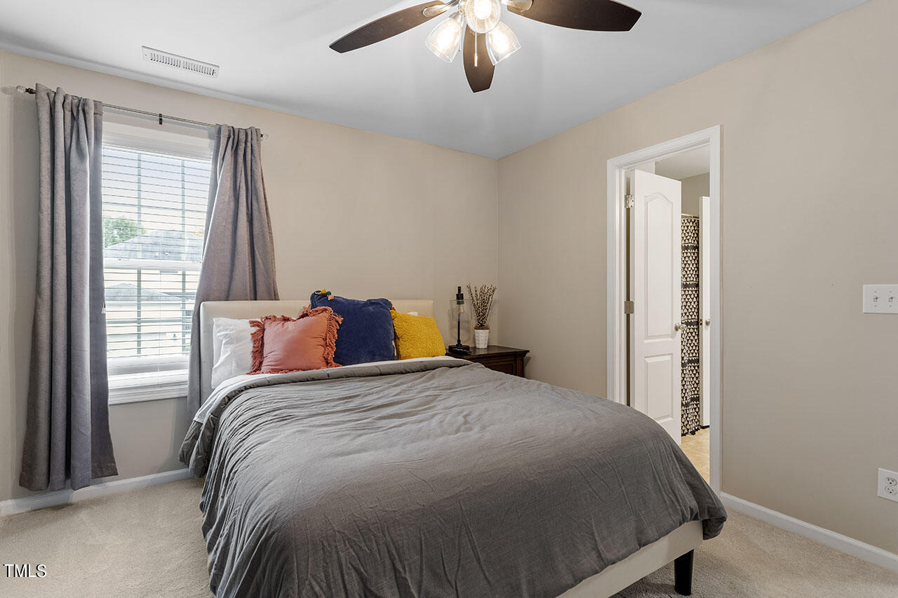 1329 Still Monument Way Raleigh, NC 27603 - Photo 28 of 42 a bedroom with a bed and window