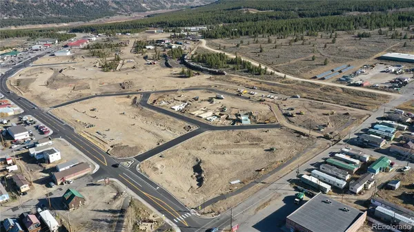 an aerial view of a residential houses with outdoor space